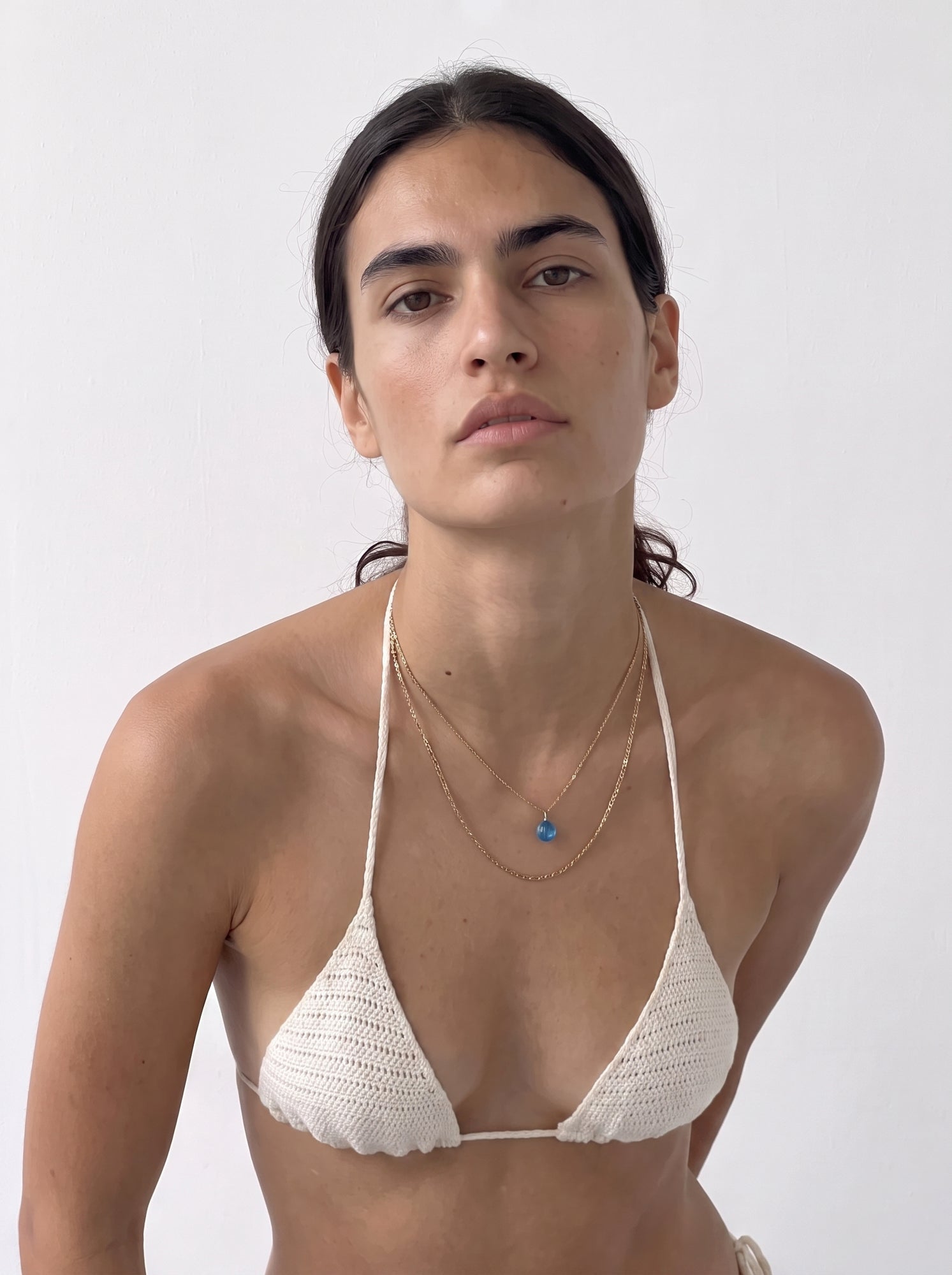 Front close-up of the handmade cream crochet triangle bikini top