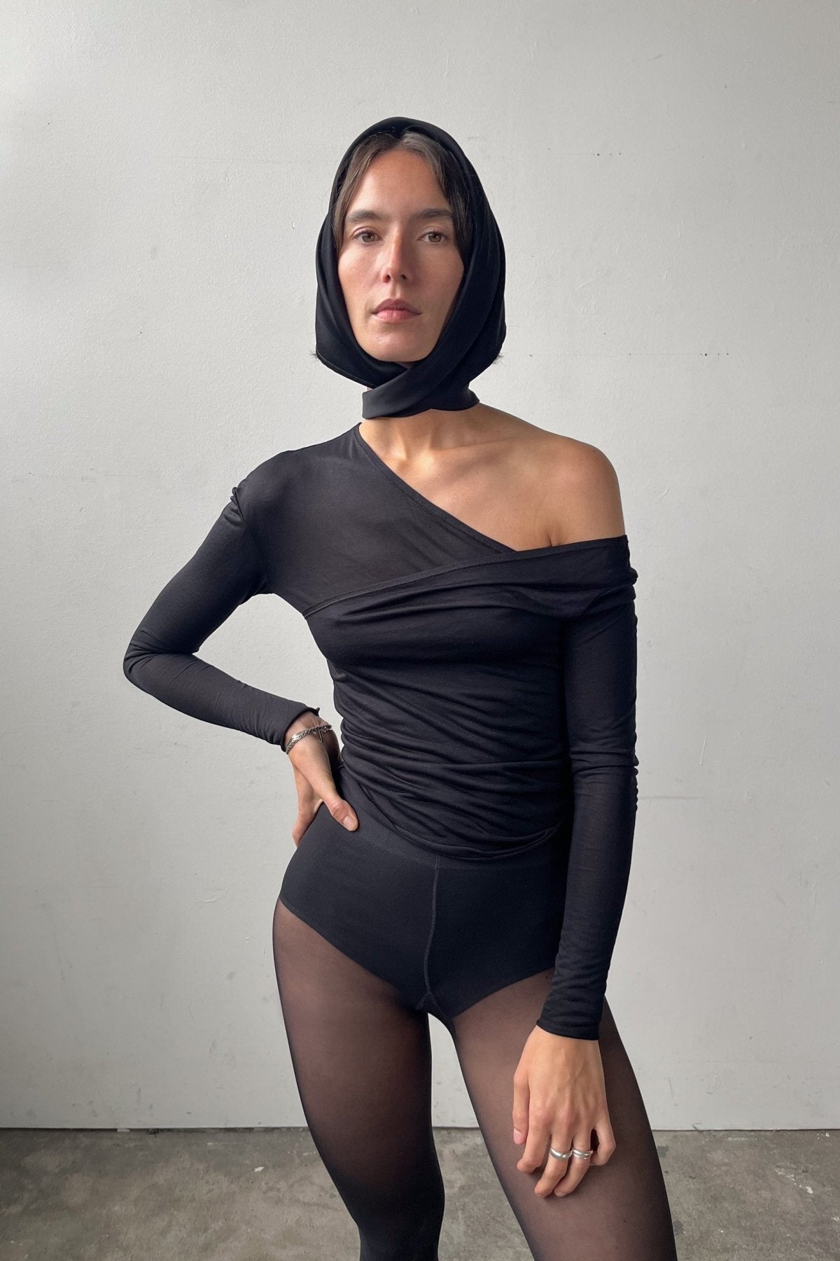 Front view of the Asymmetric V-Neck Long Sleeve Top in black, crafted from a soft, eco-conscious Micromodal.