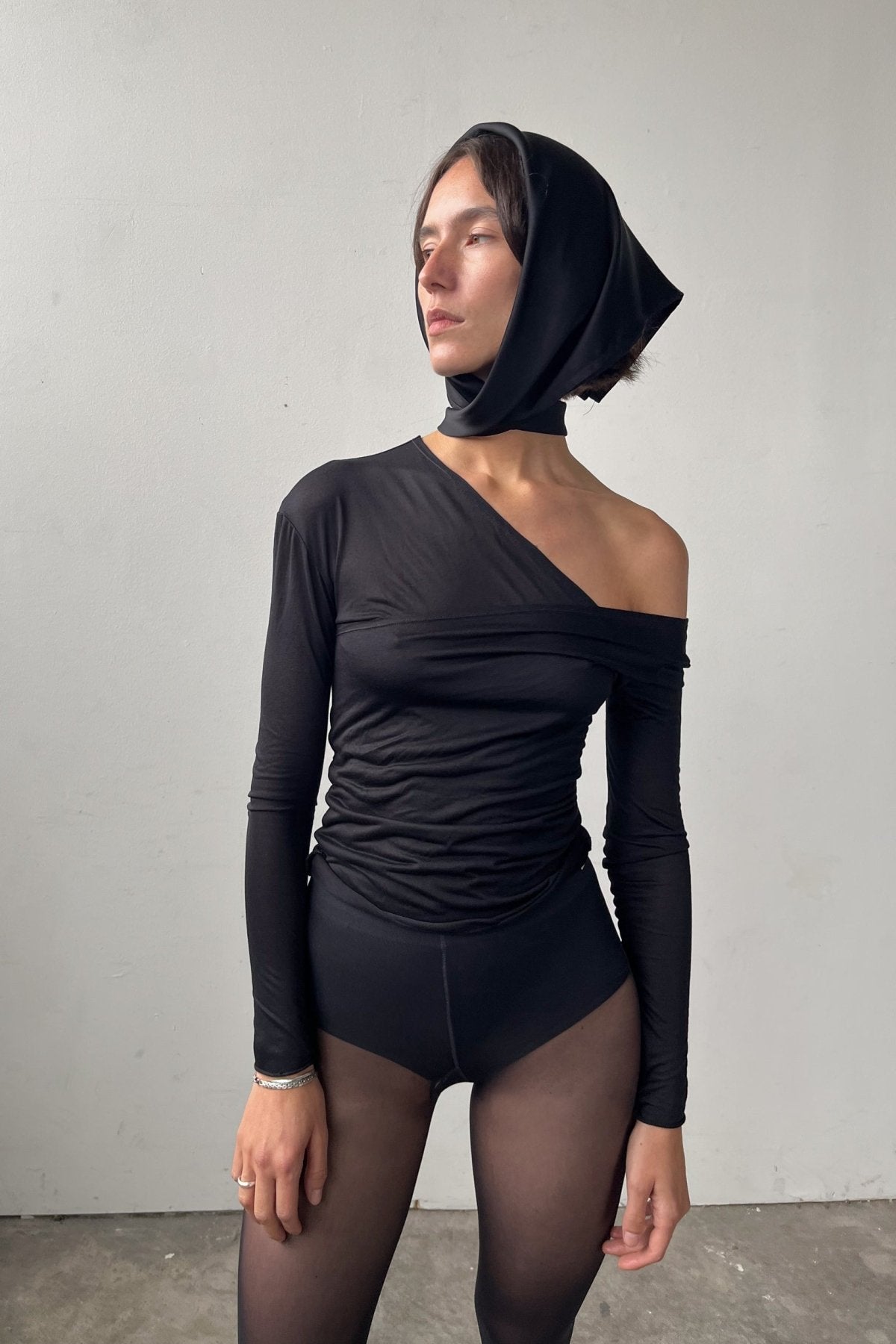 Front view of the Asymmetric V-Neck Long Sleeve Top in black, crafted from a soft, eco-conscious Micromodal.