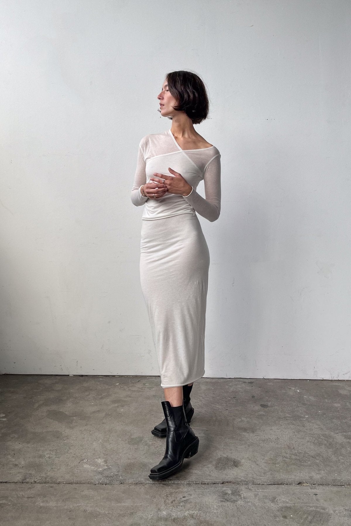 Full body front view of the Asymmetric V-Neck Long Sleeve Top in Off White, crafted from a soft blend of recycled wool and modal.