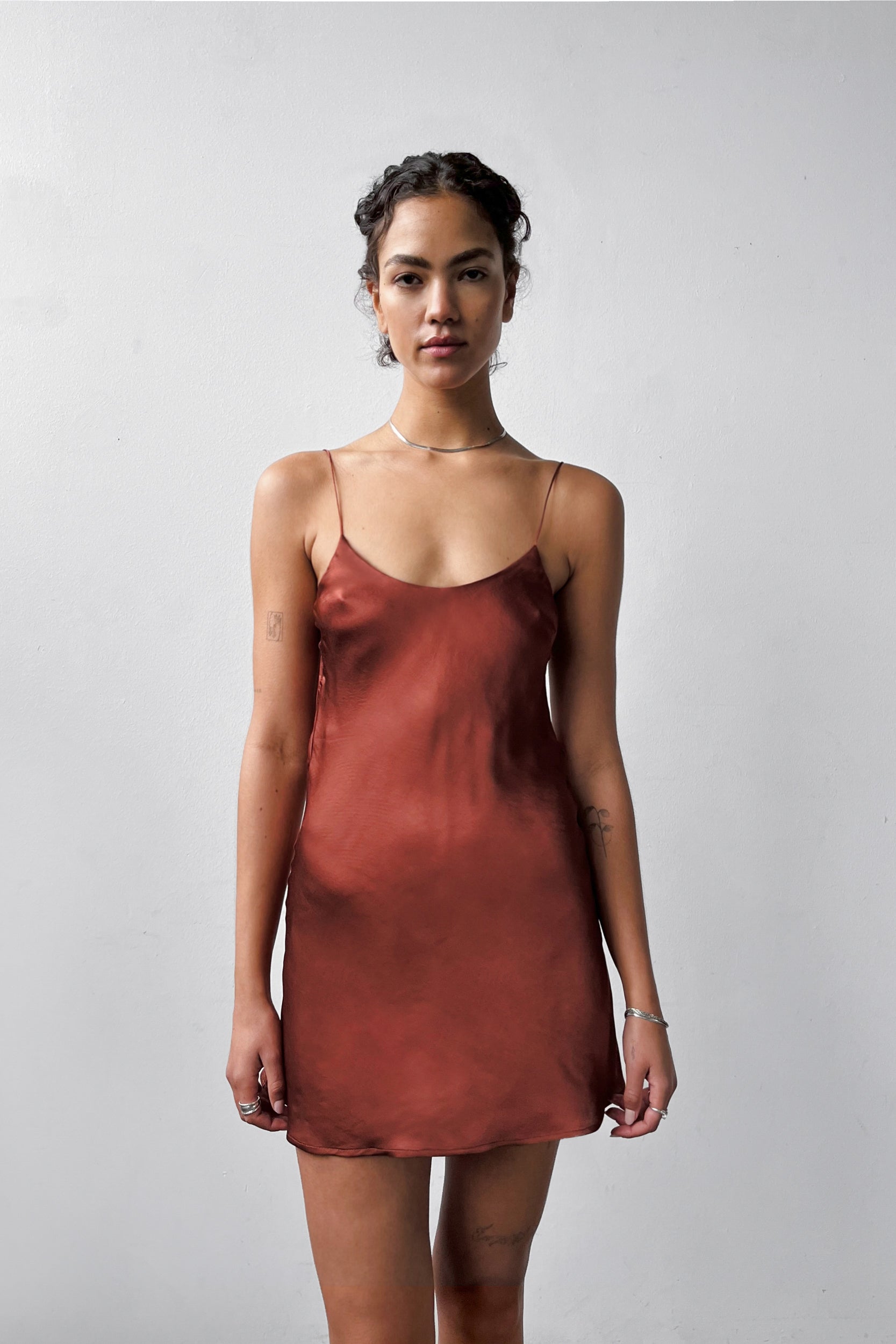 Front view of the Backless Short Slip Dress in R, featuring thin straps and a flattering silhouette in eco-certified satin.