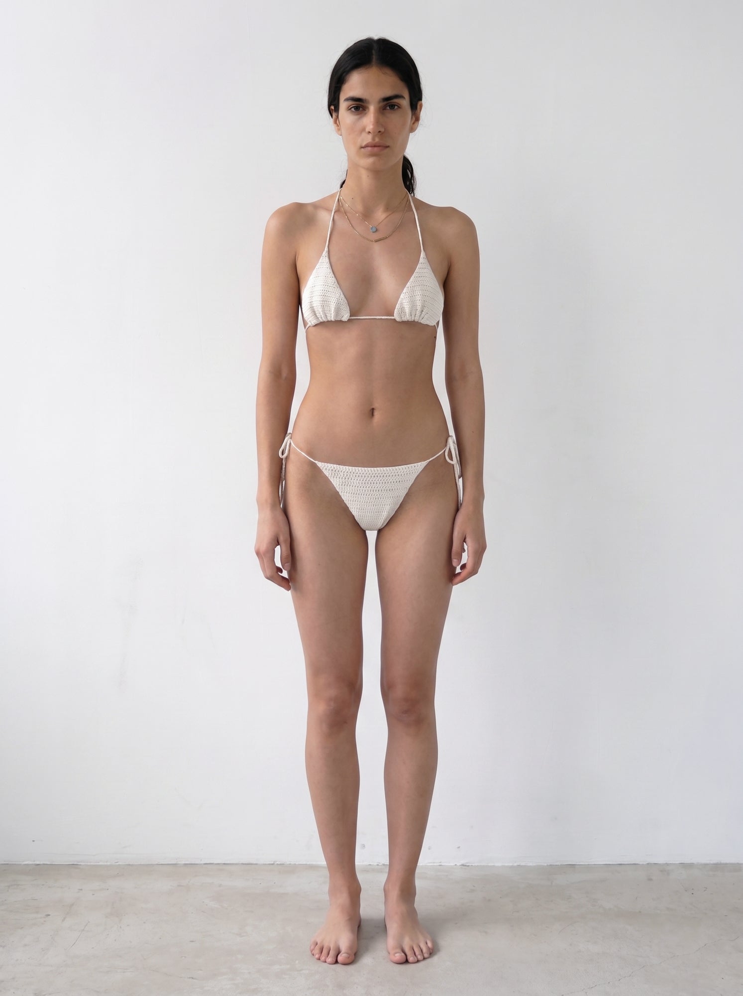 Full-length front view of the cream crochet bikini top with matching bottom
