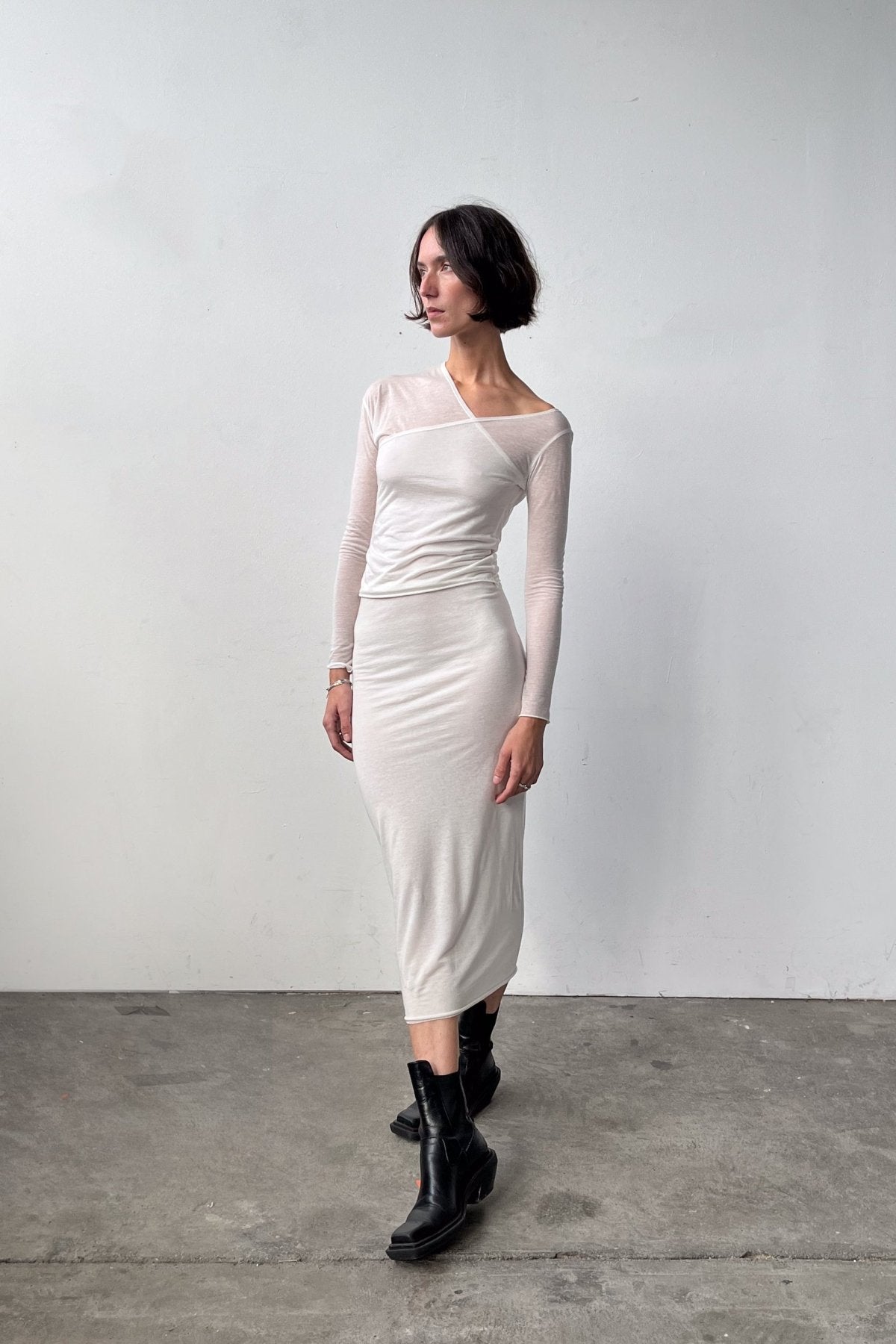 Full body front view of the Asymmetric V-Neck Long Sleeve Top in Off White, crafted from a soft blend of recycled wool and modal. 