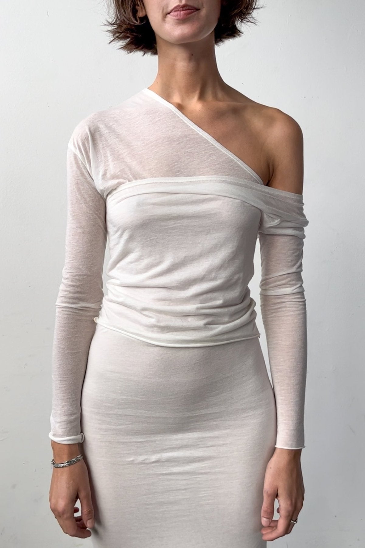 Front view of the Asymmetric V-Neck Long Sleeve Top in Off White, crafted from a soft blend of recycled wool and modal. 